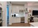 Stylish bar area with custom cabinetry, wine storage, and beverage fridge at 8722 Backshore Ln, Parrish, FL 34219
