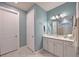 Bright bathroom featuring white cabinetry, and a well lit vanity mirror at 8722 Backshore Ln, Parrish, FL 34219