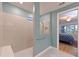 Tiled walk-in shower with a built-in seat and window to provide natural light at 8722 Backshore Ln, Parrish, FL 34219