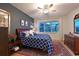 Bedroom with a window offering views, complemented by a stylish ceiling fan and decor at 8722 Backshore Ln, Parrish, FL 34219