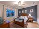 Cozy bedroom with a ceiling fan, bedside table and striking blue accent wall at 8722 Backshore Ln, Parrish, FL 34219