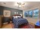 Comfortable bedroom with a large window, soft lighting, and stylish decor at 8722 Backshore Ln, Parrish, FL 34219