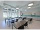 Well-lit classroom featuring large windows, modern tables and chairs, plus a built in sink and cabinets at 8722 Backshore Ln, Parrish, FL 34219