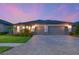 Charming home with a paver driveway, two-car garage, and manicured lawn at 8722 Backshore Ln, Parrish, FL 34219