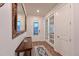 Inviting foyer with wood floors, a decorative mirror, and a stylish console table at 8722 Backshore Ln, Parrish, FL 34219