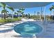 Relaxing hot tub with clear water, surrounded by comfortable seating and lush tropical landscaping at 8722 Backshore Ln, Parrish, FL 34219