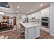 Bright, modern kitchen with white cabinetry, stainless appliances, and an island at 8722 Backshore Ln, Parrish, FL 34219