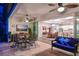 Covered patio with ceiling fans, dining table, outdoor seating, and sliding glass doors to the home's interior at 8722 Backshore Ln, Parrish, FL 34219