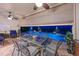 Covered patio with dining area overlooking a beautiful private pool at night at 8722 Backshore Ln, Parrish, FL 34219