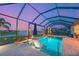 Tranquil screened pool area with seating and lake views at 8722 Backshore Ln, Parrish, FL 34219