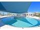 Inviting pool and outdoor dining area with shaded seating, perfect for relaxation and entertainment at 8722 Backshore Ln, Parrish, FL 34219