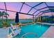 Screened-in pool with water features overlooking a serene lake view at 8722 Backshore Ln, Parrish, FL 34219