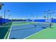 Well-maintained tennis courts with new blue fencing offer a perfect spot for recreation at 8722 Backshore Ln, Parrish, FL 34219