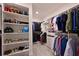 Spacious walk-in closet with custom shelving and ample storage for clothing and shoes at 8722 Backshore Ln, Parrish, FL 34219