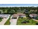 Aerial view of a home with lush landscaping, and nearby water views at 9011 Hilolo Ln, Venice, FL 34293
