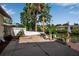 Backyard concrete patio with grill and canal views at 9011 Hilolo Ln, Venice, FL 34293