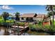 Backyard showing patio, deck, landscaping, and boat dock, perfect for outdoor living near the water at 9011 Hilolo Ln, Venice, FL 34293