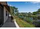 Relaxing backyard view with patio, lush greenery, and a peaceful canal view perfect for entertaining at 9011 Hilolo Ln, Venice, FL 34293