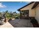 View of the backyard concrete patio with outdoor kitchen and canal views at 9011 Hilolo Ln, Venice, FL 34293