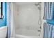 White bathroom with shower and tub combination and white tile at 9011 Hilolo Ln, Venice, FL 34293