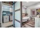Bright renovated bathroom featuring wood-like tile floors, soaking tub, and white sink/vanity at 9011 Hilolo Ln, Venice, FL 34293