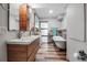Stylish bathroom featuring wood plank tile, a claw foot tub, double sink vanity, and glass enclosed shower at 9011 Hilolo Ln, Venice, FL 34293