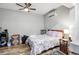 Cozy bedroom with ceiling fan, hardwood floors, and simple decor at 9011 Hilolo Ln, Venice, FL 34293