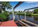 View of the canal from a private dock with a boat lift, showcasing the serene waterfront living and boating opportunities at 9011 Hilolo Ln, Venice, FL 34293