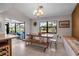 Dining area with natural lighting, a chandelier, and a wooden table and seating at 9011 Hilolo Ln, Venice, FL 34293