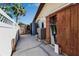 Exterior view of the property showing the utility area, featuring a shed, A/C unit and water conditioning equipment at 9011 Hilolo Ln, Venice, FL 34293