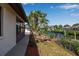 Lovely home exterior featuring a patio, mature trees, and a tranquil canal for waterfront living at 9011 Hilolo Ln, Venice, FL 34293