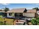 Home exterior features a patio, backyard deck, lush plants, and an outdoor grill perfect for entertaining guests at 9011 Hilolo Ln, Venice, FL 34293