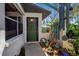 Inviting front entrance with decorative plants, attractive walkway and glass-paneled windows at 9011 Hilolo Ln, Venice, FL 34293