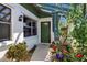 Inviting front entrance with decorative plants, attractive walkway and glass-paneled windows at 9011 Hilolo Ln, Venice, FL 34293