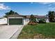 Charming home with a well-kept lawn, attached garage, and attractive landscaping at 9011 Hilolo Ln, Venice, FL 34293