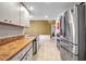 Spacious kitchen featuring countertops and stainless-steel refrigerator, providing a modern aesthetic at 9011 Hilolo Ln, Venice, FL 34293