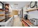 Bright kitchen featuring stainless steel appliances, countertop coffee maker, and decorative rustic accents at 9011 Hilolo Ln, Venice, FL 34293