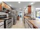 Well-lit kitchen featuring stainless steel appliances, ample counter space, and modern cabinetry at 9011 Hilolo Ln, Venice, FL 34293