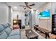 Cozy living room with TV, comfortable sofa, and stylish decor at 9011 Hilolo Ln, Venice, FL 34293