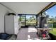 Enclosed patio featuring large windows, white tiled floors and exterior scenery at 9011 Hilolo Ln, Venice, FL 34293
