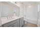 Bright bathroom features a double sink vanity with a shower over tub with tiled walls at 9035 Duany Ln, Lakewood Ranch, FL 34240