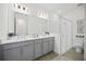 Bathroom features double sinks, gray cabinets, and a glass-enclosed shower at 9035 Duany Ln, Lakewood Ranch, FL 34240
