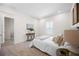 Bedroom featuring neutral carpet, large windows, and simple, elegant design at 9035 Duany Ln, Lakewood Ranch, FL 34240