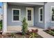 Inviting front porch with decorative plants and a view of the front yard at 9035 Duany Ln, Lakewood Ranch, FL 34240