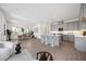 Open kitchen with modern cabinetry, white countertops, and island seating at 9035 Duany Ln, Lakewood Ranch, FL 34240