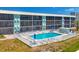 Aerial view of the community pool showing loungers and a patron enjoying the day at 9200 Midnight Pass Rd # 24, Sarasota, FL 34242