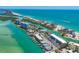 Breathtaking aerial view showcases waterfront homes, docks, and vibrant turquoise waters at 9200 Midnight Pass Rd # 24, Sarasota, FL 34242