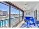 Relaxing screened balcony featuring comfortable seating, a ceiling fan, and scenic water views at 9200 Midnight Pass Rd # 24, Sarasota, FL 34242