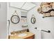 Charming bathroom with granite vanity, decorative mirrors, and ample towel storage for added convenience at 9200 Midnight Pass Rd # 24, Sarasota, FL 34242