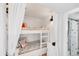 Cozy bunk room with built-in beds, nautical-themed decor, and a private bathroom, perfect for children at 9200 Midnight Pass Rd # 24, Sarasota, FL 34242